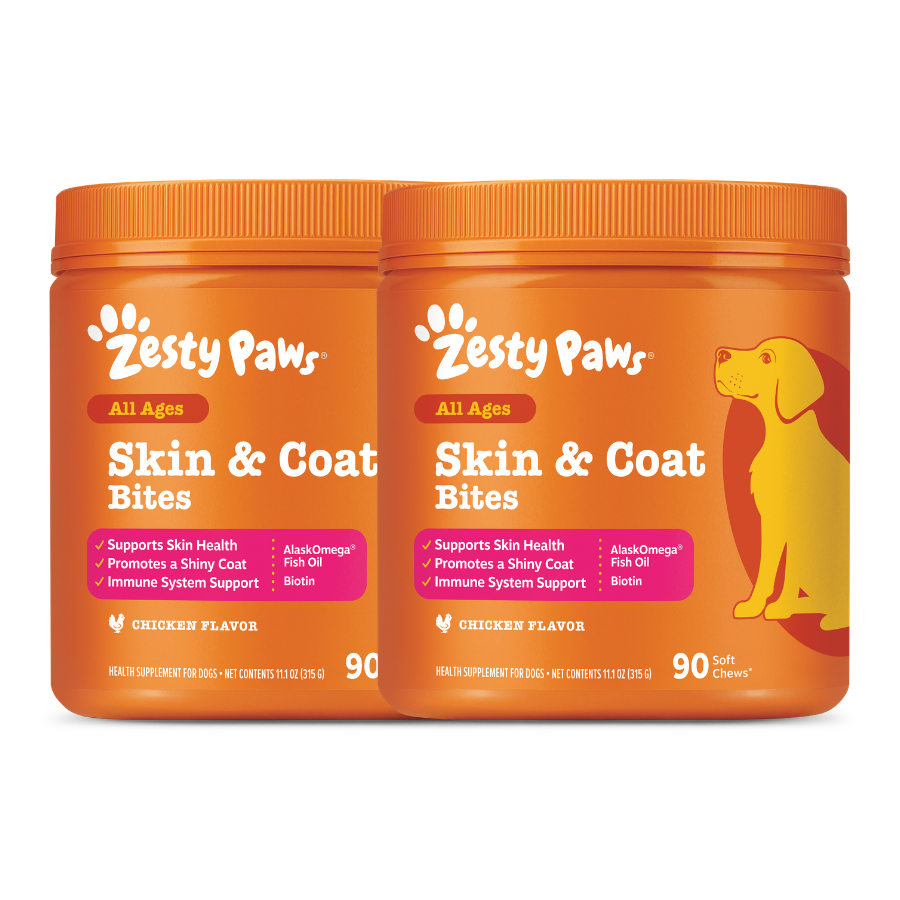 Two orange Zesty Paws Skin & Coat Bites containers with chicken flavor and a yellow dog illustration on the right container.