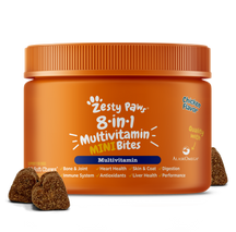 Orange plastic jar with orange ridged cap containing brown multivitamin bites for dogs, with three bite-sized pieces displaye