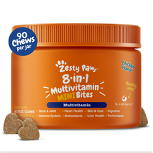 Orange jar of Zesty Paw 8-in-1 Multivitamin Mini Bites with blue lid and three tan-colored chews displayed in front.