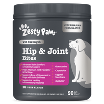 Dark gray container of Zesty Paws Vet Strength Hip & Joint Bites for dogs with white labeling, featuring a white dog illustra