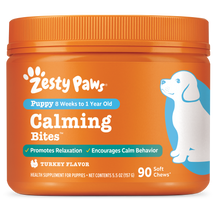 Orange plastic container of Zesty Paws Calming Bites for puppies with white and blue labeling and illustration of a white and