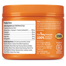 Orange jar of Calming Bites puppy treats with product facts label and ingredients list visible on front.