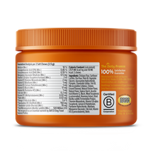 Orange plastic jar with orange ridged cap containing puppy multivitamin bites, nutrition label and ingredient list visible on