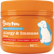 Orange jar of Zesty Paws puppy allergy and immune bites with blue illustration of a dog and orange ribbed cap.