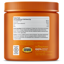 Orange plastic jar with ridged cap containing dog supplement soft chews, showing product facts label and certification seals.