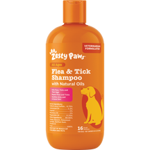 Orange bottle of Zesty Paws flea and tick shampoo with natural oils, 16 fl oz, featuring paw print logo and yellow dog illust