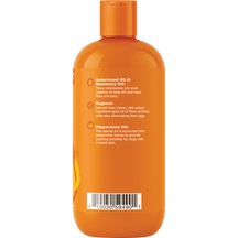 Orange plastic bottle of dog shampoo with orange cap and ingredient information printed on label.
