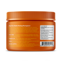 Orange jar with ridged orange cap containing tan-colored powder supplement for dogs with product label and usage instructions