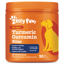 Orange bottle of Zesty Paws Turmeric Curcumin Bites dog supplement with yellow dog illustration and product details.