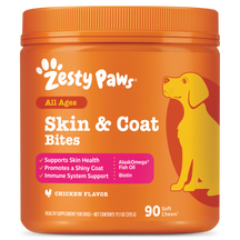Orange jar of Zesty Paws Skin & Coat Bites dog supplement with yellow dog illustration and red accent bands.