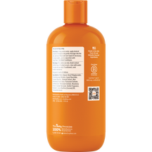 Orange bottle of dog shampoo with cap, ingredient list, and B Corporation certification label on back.