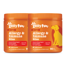 Two orange Zesty Paws Allergy & Immune Bites containers with lamb flavor and yellow dog illustration on right jar.