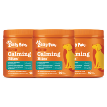 Three orange Zesty Paws Calming Bites containers with peanut butter flavor and yellow dog illustrations on the labels.