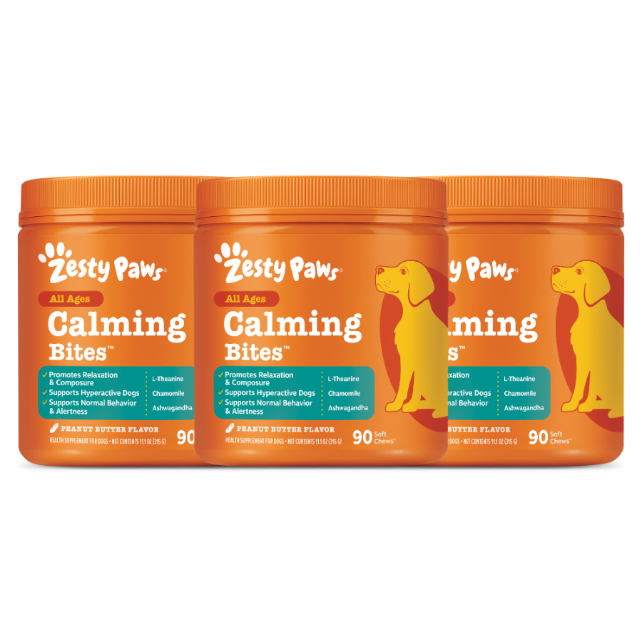 Three orange Zesty Paws Calming Bites containers with peanut butter flavor and yellow dog illustrations on the labels.