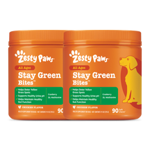Two orange Zesty Paws Stay Green Bites containers with chicken flavor, 90 soft chews each, featuring a yellow dog illustratio