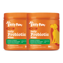 Two orange Zesty Paws Daily Probiotic Bites containers with pumpkin flavor and yellow dog illustration on label.