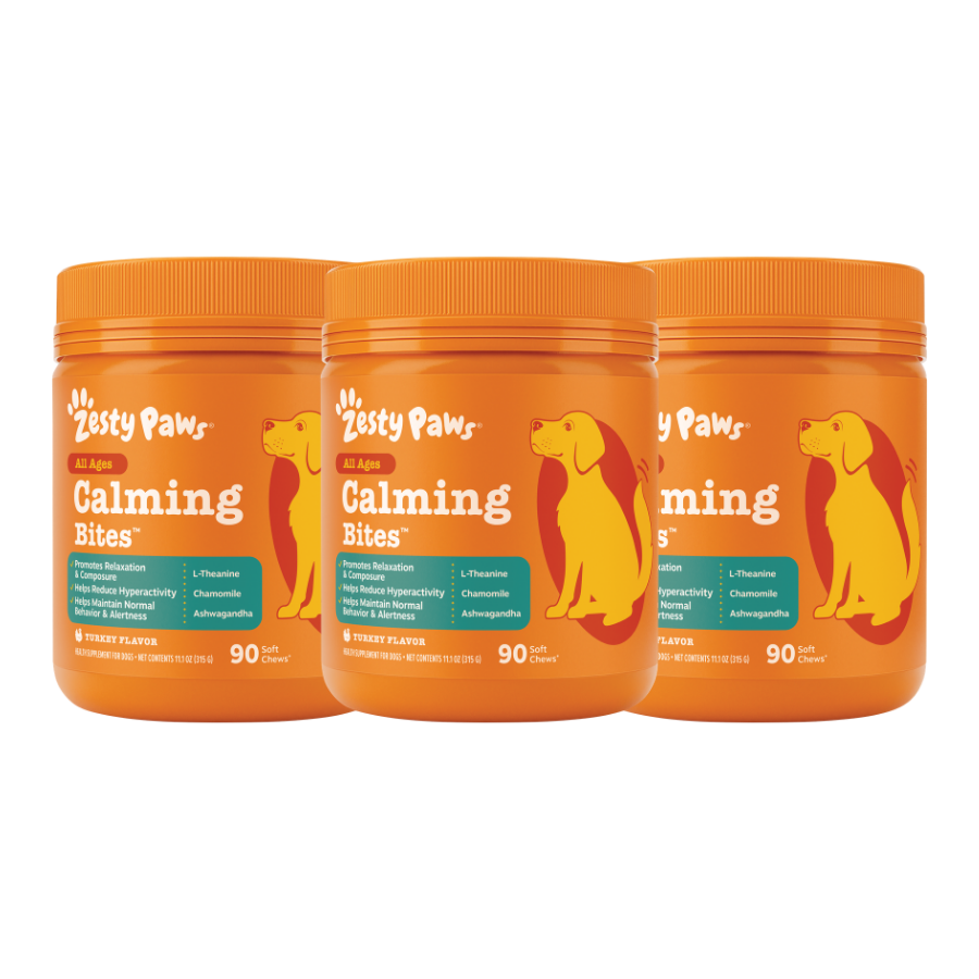 Three orange Zesty Paws Calming Bites containers with yellow dog silhouettes and teal labels, each containing 90 chews.