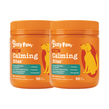 Two orange Zesty Paws Calming Bites bottles with dog silhouettes, containing 90 soft chews each in turkey flavor.