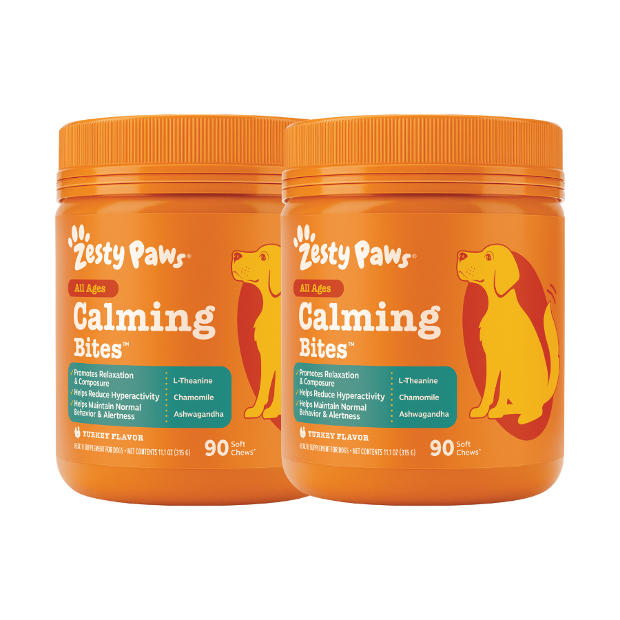 Two orange Zesty Paws Calming Bites bottles with dog silhouettes, containing 90 soft chews each in turkey flavor.