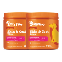 Two orange Zesty Paws Skin & Coat Bites containers with chicken flavor and a yellow dog illustration on the right container.