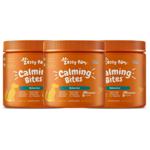 Three orange plastic jars of Zesty Paw Calming Bites soft chews for dogs with orange ribbed caps.