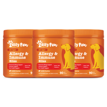 Three orange jars of Zesty Paw Allergy & Immune Bites with yellow dog silhouettes and lamb flavor labels.