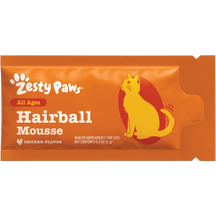 Orange Zesty Paws hairball mousse packet with yellow cat illustration and chicken flavor label.