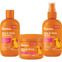 Three orange Zesty Paws flea and tick products: shampoo bottle, bite chews jar, and spray bottle.